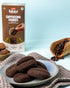 Millet Cappuccino Cookies on a plate with coffee beans and product packaging in the background