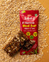 Millets & Oats Meal Bar with seeds, almonds, and dates on oat flakes background, high protein and fiber snack