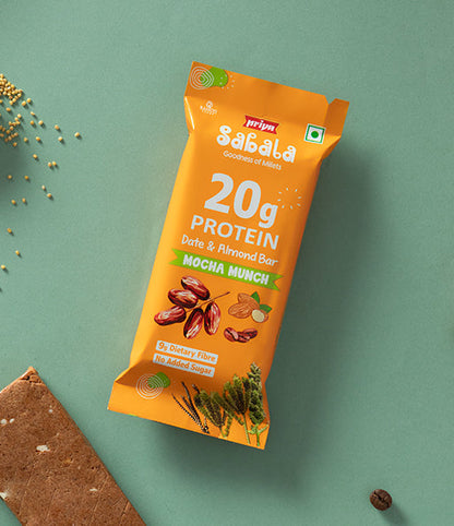 Mocha Munch Date &amp; Almond Bar packaging showing protein content and dry fruit ingredients on a green background with millet grains and coffee bean.