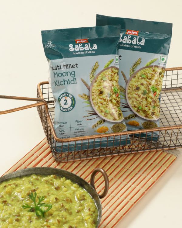 Multi Millet Moong Kichidi packets with a bowl of cooked moong kichidi garnished with cilantro