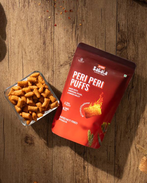 Peri Peri Puffs multigrain spicy chili and garlic flavored snack with sorghum, pearl, and finger millet in red packaging and bowl of puffs on wooden surface