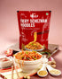 Millet Fiery Schezwan Noodles package with bowl of spicy Hakka noodles and fresh ingredients on table