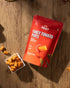 Tangy Tomato Puffs snack package with tomato-flavored puffed millet chips on wooden surface